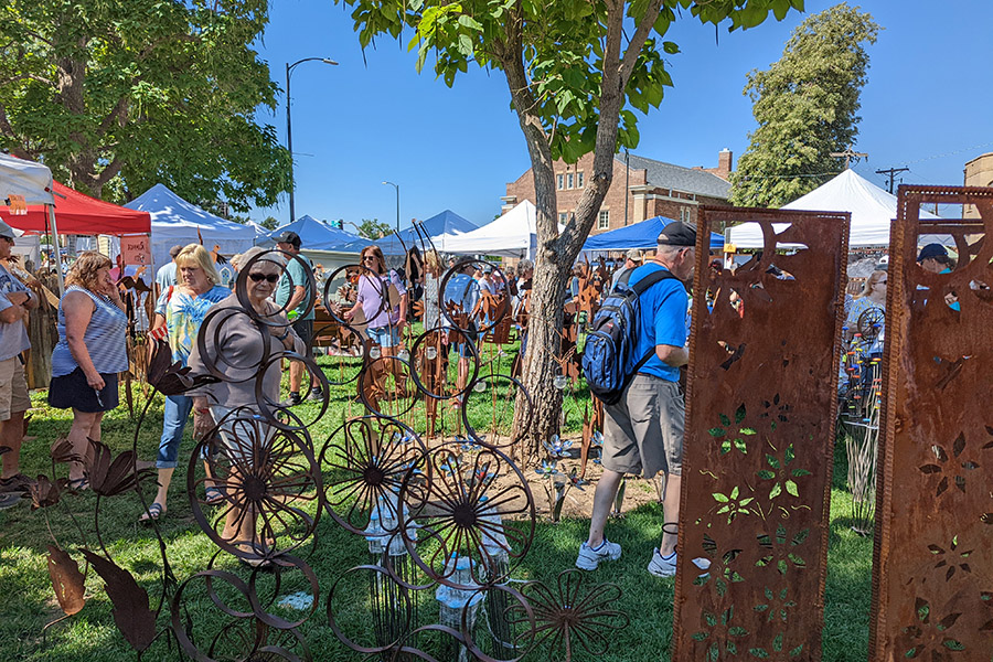Photo of Greeley Arts Picnic patrons checking out an art booth