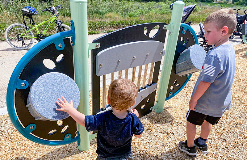 Photo of young children checking out new playground equipment