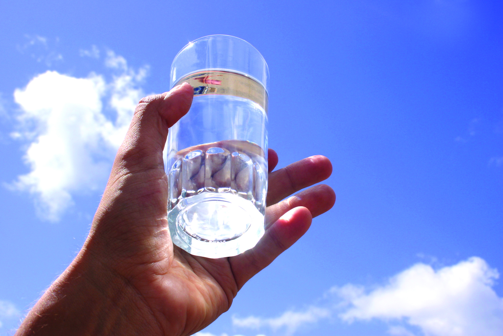 Glass of water in a person's hand