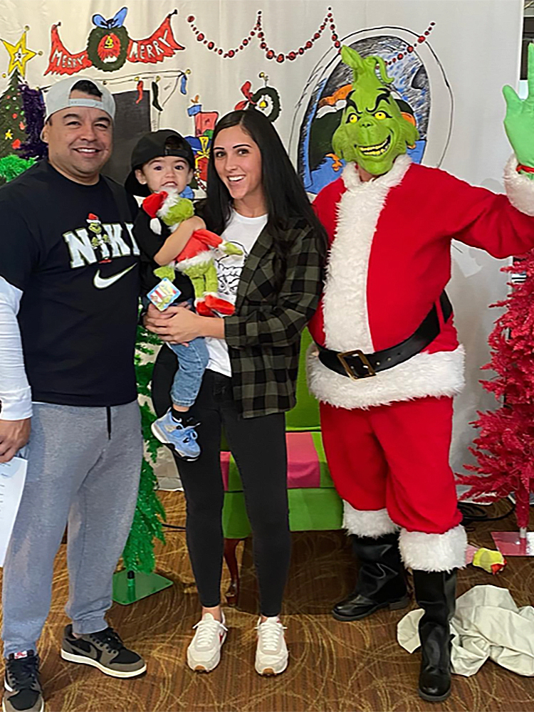 photo of a family posing with the Grinch