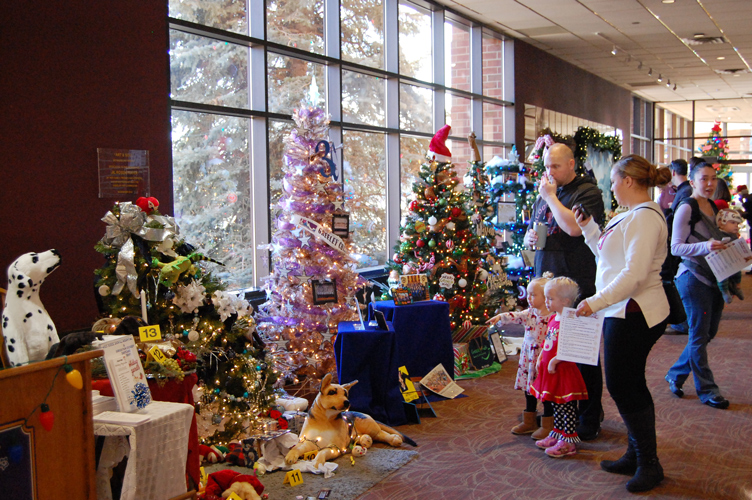 Photo of young family viewing Christmas trees at Greeley's Festival of Trees