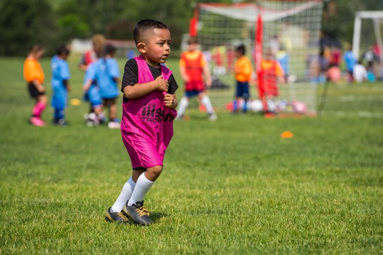 Kid playing soccer at with Greeley Recreation youth sports