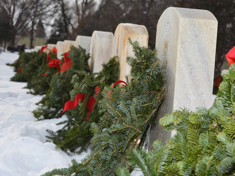 headstones with wreaths and snow
