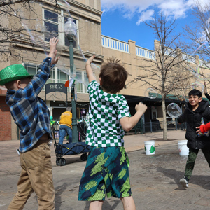 Children playing with bubbles in downtown Greeley.