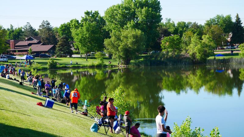 Greeley residents surround the pond at Sanborn Park during the fishing derby.