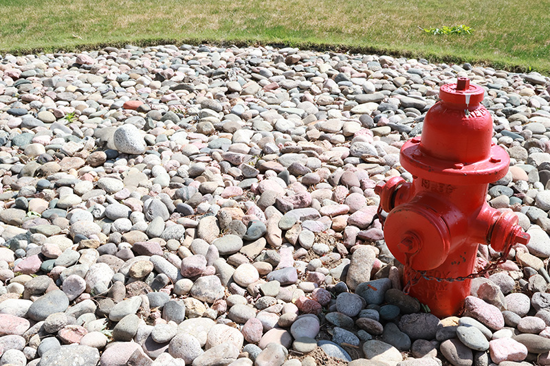 Fire hydrant surrounded by landscaping rocks